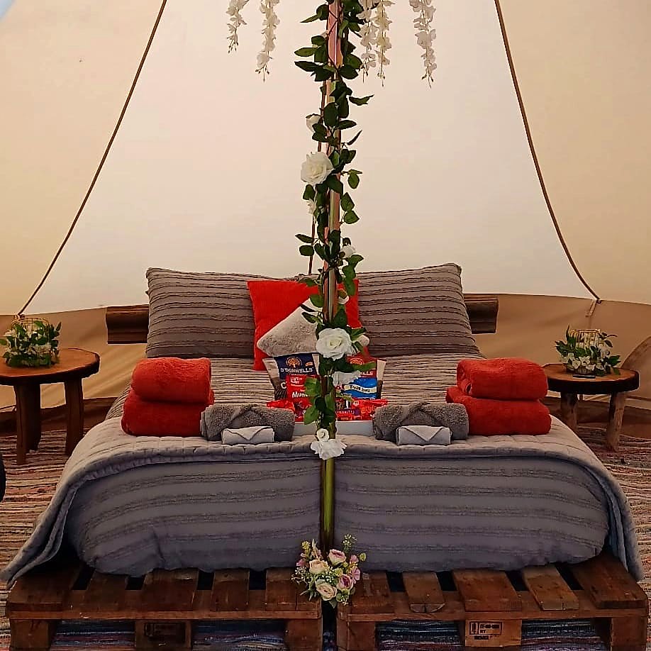 The made-up double bed in Fairy Fort with towels, cushions and a welcome treat tray