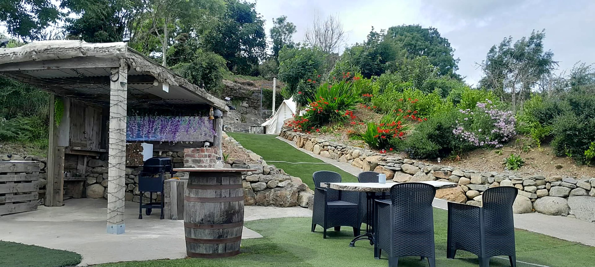 Stone terraces, planting in flower and the seating area beside Fairy Cove